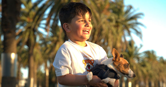 A happy kid carrying puppy wearing adorable lion tshirt from Krazebear