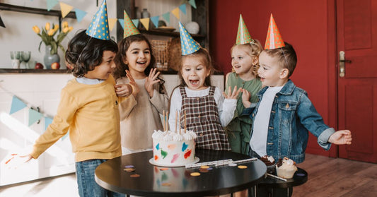 Adorable children dressed in fashionable attire joyfully celebrating a birthday